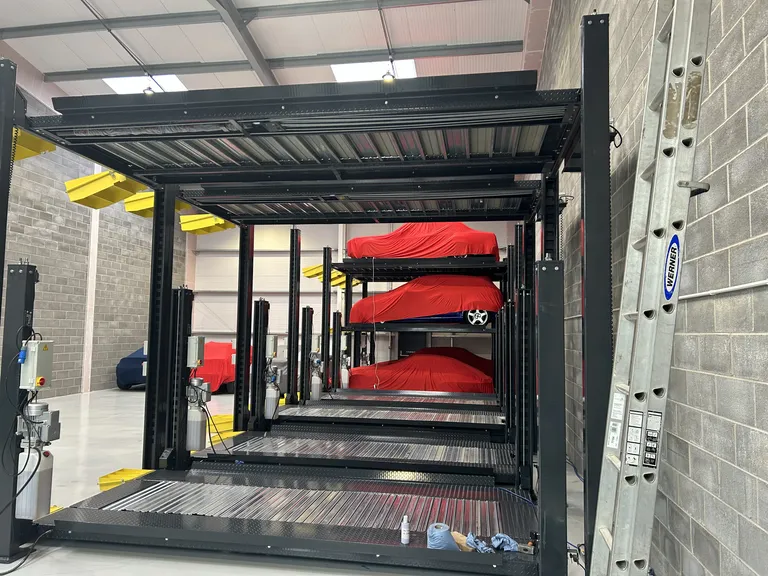 Strongman Lifts - Bewdley triple stackers installed in a car storage facility