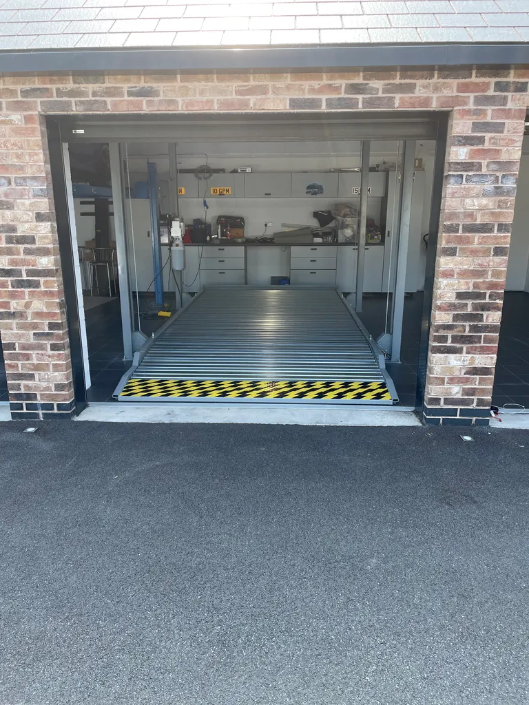 Strongman Lifts - Dean parking four post car lift installed perfectly aligned to garage doors