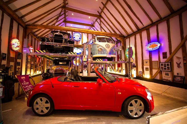 Strongman Lifts - Alness four post lift installed in a dream garage