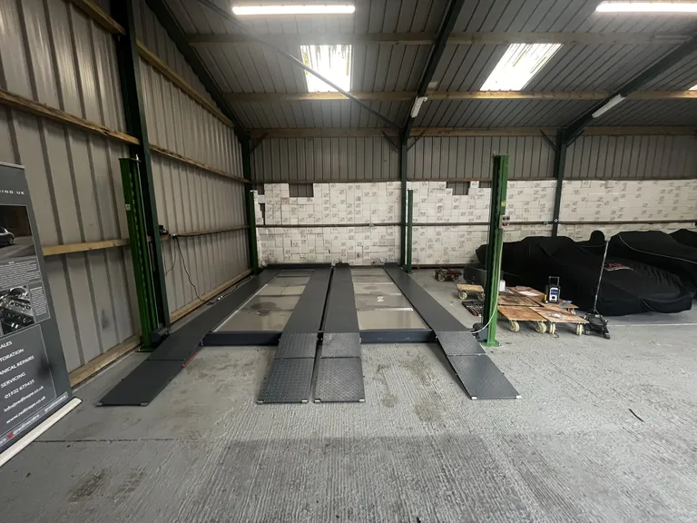 Strongman Lifts - Forth car parking lift installed in a car storage facility