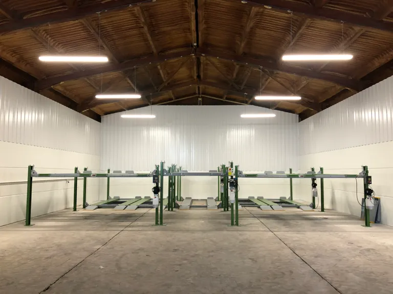 Strongman Lifts - Forth car parking lift installed in a car storage facility